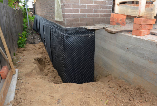 SJ Waterproofing Pros technician performing targeted Wet Basement Repair assessment in Opelika, AL